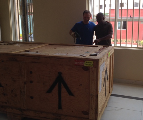 Stephen Small with Chike Chuka opening the Accu SPINA shipping crate